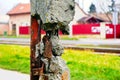 grunge cracked concrete post with exposed rusty steel reinforcing rebars. soft blurred background Royalty Free Stock Photo