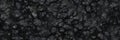 Grunge dark gray rocks pr nature stone texture background. Old with grain grey and black cracked volcanic ash