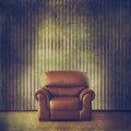 Grunge filtered interior with vintage wallpaper and classic leather armchair Royalty Free Stock Photo