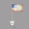 Grunge flag of USA on a stick, in a small bucket. Isolated on a gray background. Signs and symbols. Flags.Design Royalty Free Stock Photo