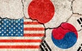 Grunge flags illustration of three countries with conflict and political problems cracked concrete background | USA, Japan and