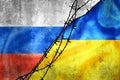 Grunge flags of Russian Federation and Ukraine divided by barb wire illustration