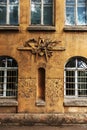 Grunge freemasonry emblem on a dramatic background - masonic triangle and compass, closeup of old architectural building