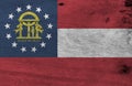 Grunge Georgia flag texture, The states of America, red white red, blue canton containing a ring of stars and coat of arms in gold Royalty Free Stock Photo