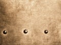 Grunge gold brown metal plate rivets screws background texture Royalty Free Stock Photo