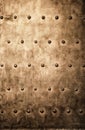 Grunge gold brown metal plate rivets screws background texture Royalty Free Stock Photo