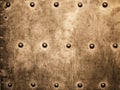 Grunge gold brown metal plate rivets screws background texture Royalty Free Stock Photo