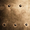 Grunge gold brown metal plate rivets screws background texture Royalty Free Stock Photo