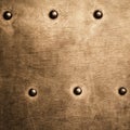 Grunge gold brown metal plate rivets screws background texture Royalty Free Stock Photo