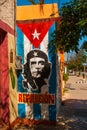 Grunge graffiti portrait of Che Guevara and Cuba flag on the wall. Varadero. Cuba