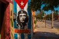 Grunge graffiti portrait of Che Guevara and Cuba flag on the wall. Varadero. Cuba