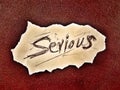 on the grunge grain color background the word serious