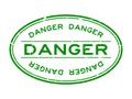 Grunge green danger word oval rubber stamp on white background