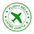 Grunge green flight delay word with airplane icon round rubber stamp on white background