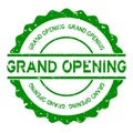 Grunge green grand opening word round rubber stamp on white background