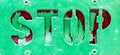 Grunge green painted Stop sign