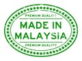 Grunge green premiumq quality made in Malaysia oval rubber business stamp on white background