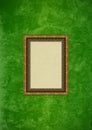 Grunge green stucco wall with empty picture frame Royalty Free Stock Photo