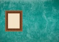 Grunge green stucco wall with empty picture frame Royalty Free Stock Photo