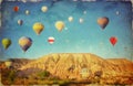 Grunge image of colorful hot air balloons against blue sky in C Royalty Free Stock Photo