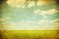 Grunge image of green field and blue sky Royalty Free Stock Photo