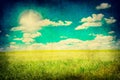 Grunge image of green field and blue sky Royalty Free Stock Photo