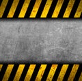 Grunge metal background with black and yellow warning stripes