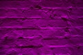 Grunge neon purple brick wall texture background. Magenta colored brick wall texture architexture pattern