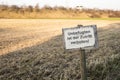 Grunge and old signboard in countryside`s crop field with text i