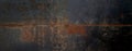 grunge orange rusty on dark black metal wall background texture used as banner panorama.