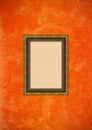 Grunge orange stucco wall with empty picture frame Royalty Free Stock Photo