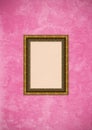 Grunge pink stucco wall with empty picture frame Royalty Free Stock Photo