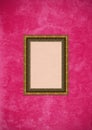 Grunge pink stucco wall with empty picture frame