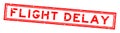 Grunge red flight delay word square rubber stamp on white background