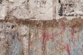 Grunge ripped poster on rusty iron sheet background - texture of torn advertisement on an old billboard panel Royalty Free Stock Photo