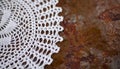 Grunge rustic background with crocheted doily on old iron surface