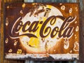 Grunge rusty retro vintage Coca-Cola metal board sign. Royalty Free Stock Photo