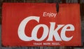 Grunge rusty retro vintage Coca-Cola metal board sign. Royalty Free Stock Photo