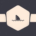 Grunge Shark fin in ocean wave icon isolated on grey background. Monochrome vintage drawing. Vector