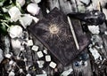Grunge still life with witch book, pentagram, runes and roses on planks