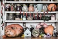 Grunge still life with wooden counters full of old utensils, bottles and jars with beans, herbs, spice, hanging hot pepper and