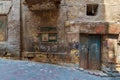 Grunge stone bricks wall with Broken wooden door and closed broken window in abandoned district Royalty Free Stock Photo