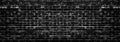 Grunge style background of wide black and white aged brick wall