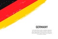 Grunge styled brush stroke background with flag of Germany Royalty Free Stock Photo