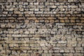 Grunge texture of an old brick wall. Background from old brown bricks. uneven texture of weathered bricks. Brick and plaster Royalty Free Stock Photo