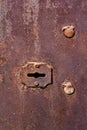 Grunge texture of an old rusty keyhole in a garage door. Royalty Free Stock Photo