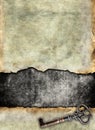 Grunge torn surface with antique key Royalty Free Stock Photo