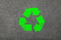 Grunge concrete background with green recycling logo sign Royalty Free Stock Photo