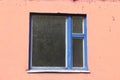 Grunge urban background texture of old orange concrete wall with window, blue wooden frame. Minimalism Royalty Free Stock Photo