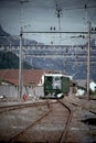 grunge vertical view of an SBB Ae 6 and 6 train moving through train tracks Erstfeld, Switzerland Royalty Free Stock Photo